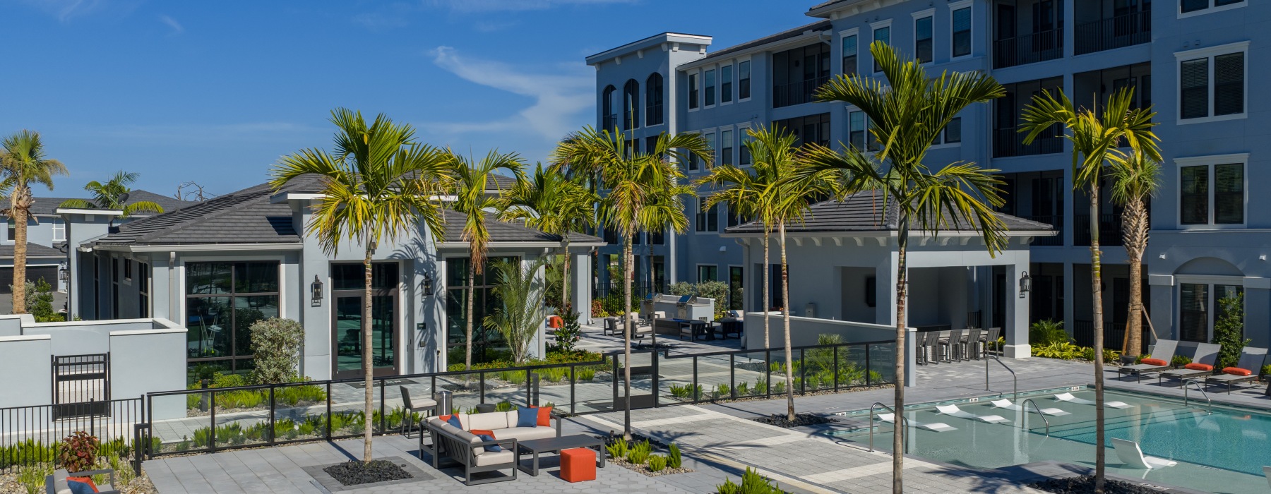 lawn game and a pool with palm trees in front of a building